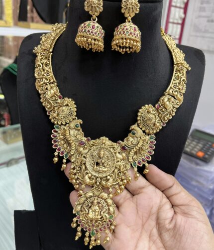 Traditional antique gold-finish necklace set featuring intricate temple-style